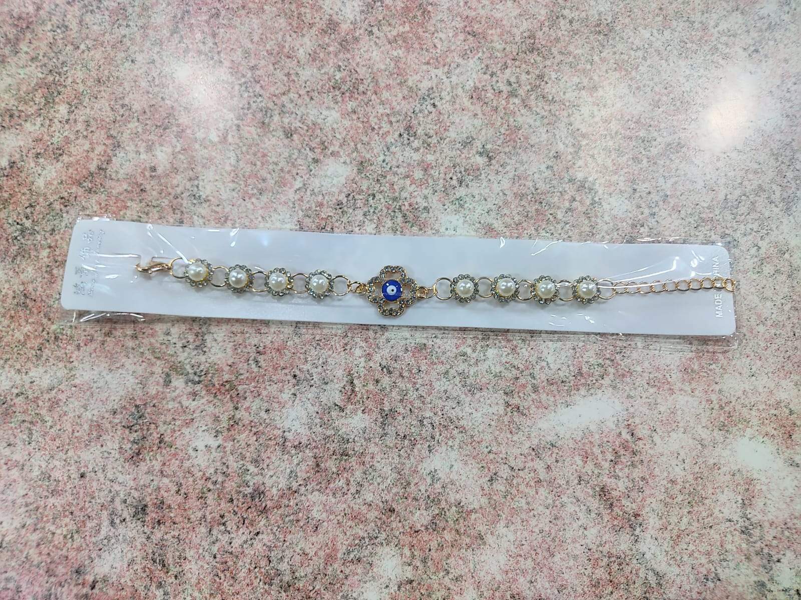 ✨ Pulsera Dorada con Perla, Ojo Turco y Dijes Variados – Por Docena ✨