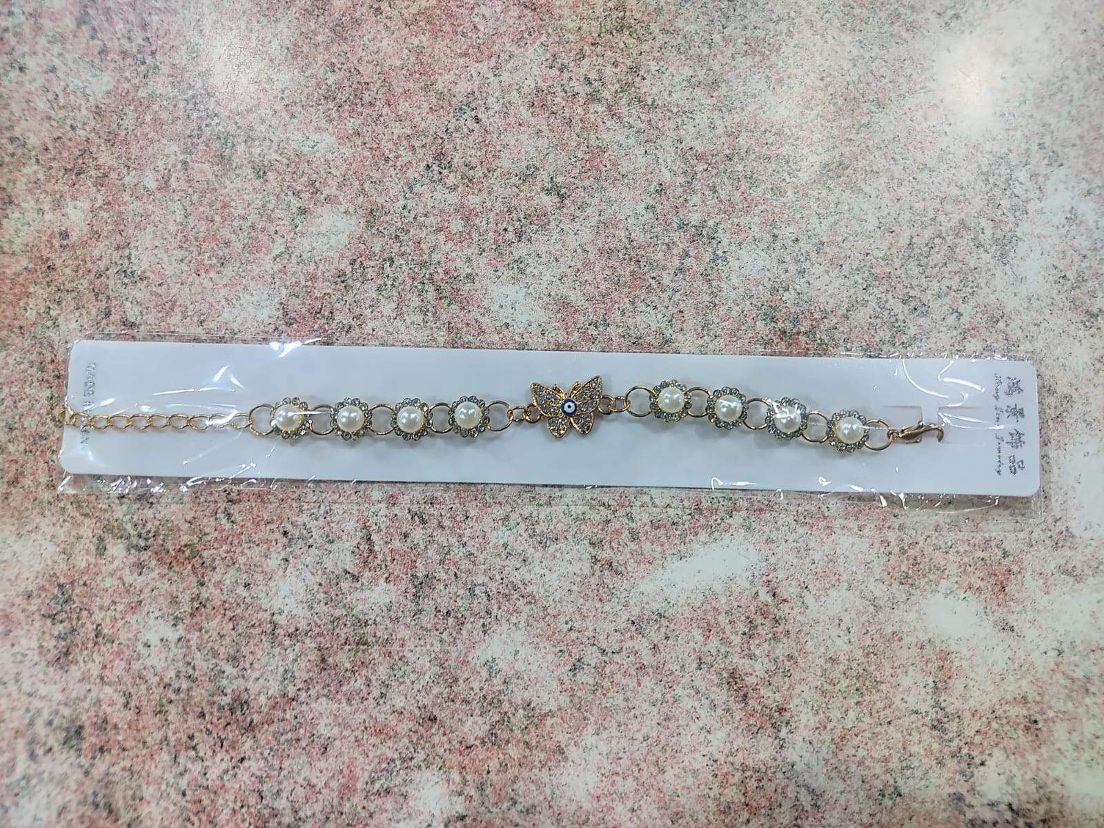 ✨ Pulsera Dorada con Perla, Ojo Turco y Dijes Variados – Por Docena ✨