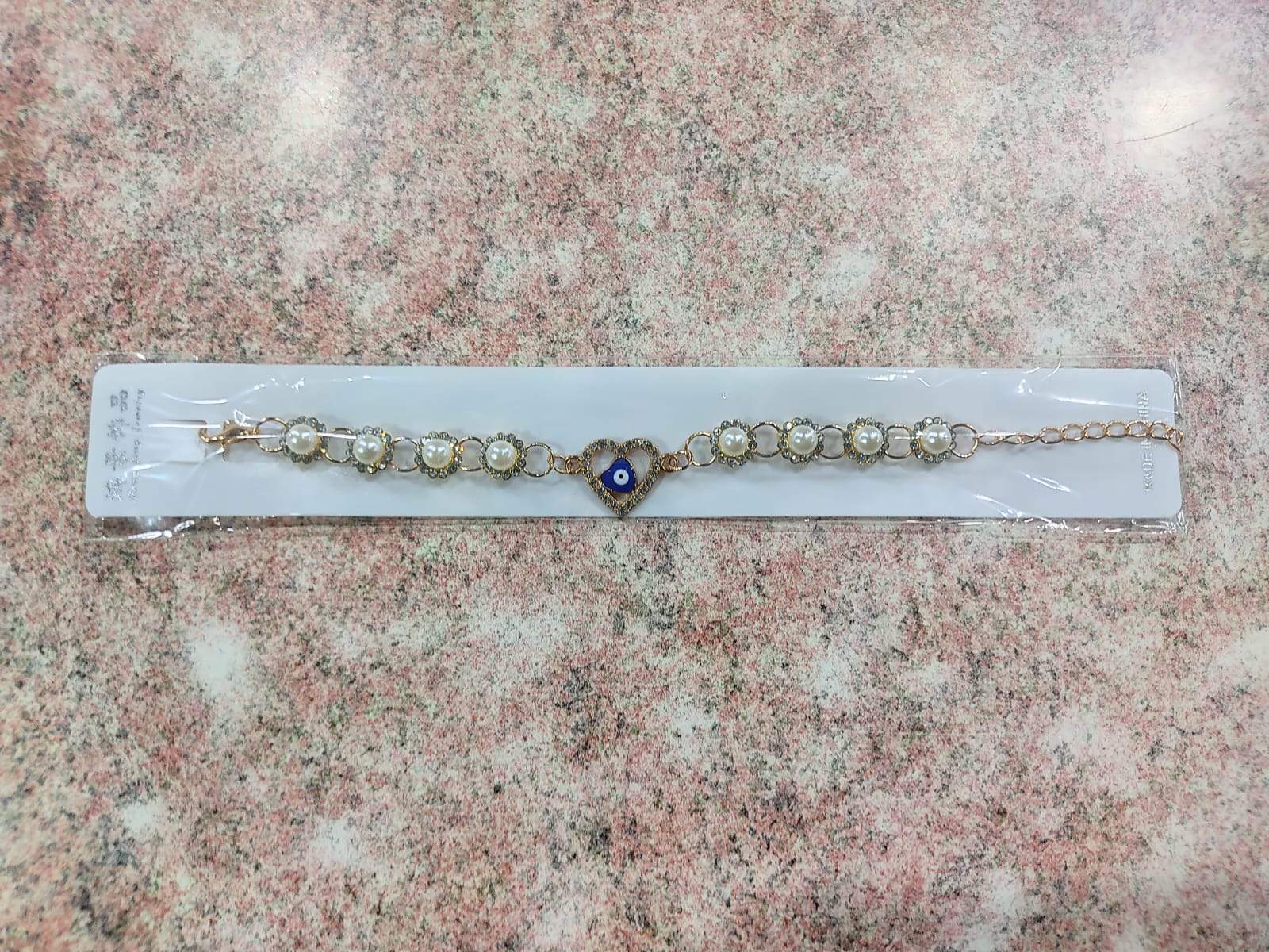✨ Pulsera Dorada con Perla, Ojo Turco y Dijes Variados – Por Docena ✨