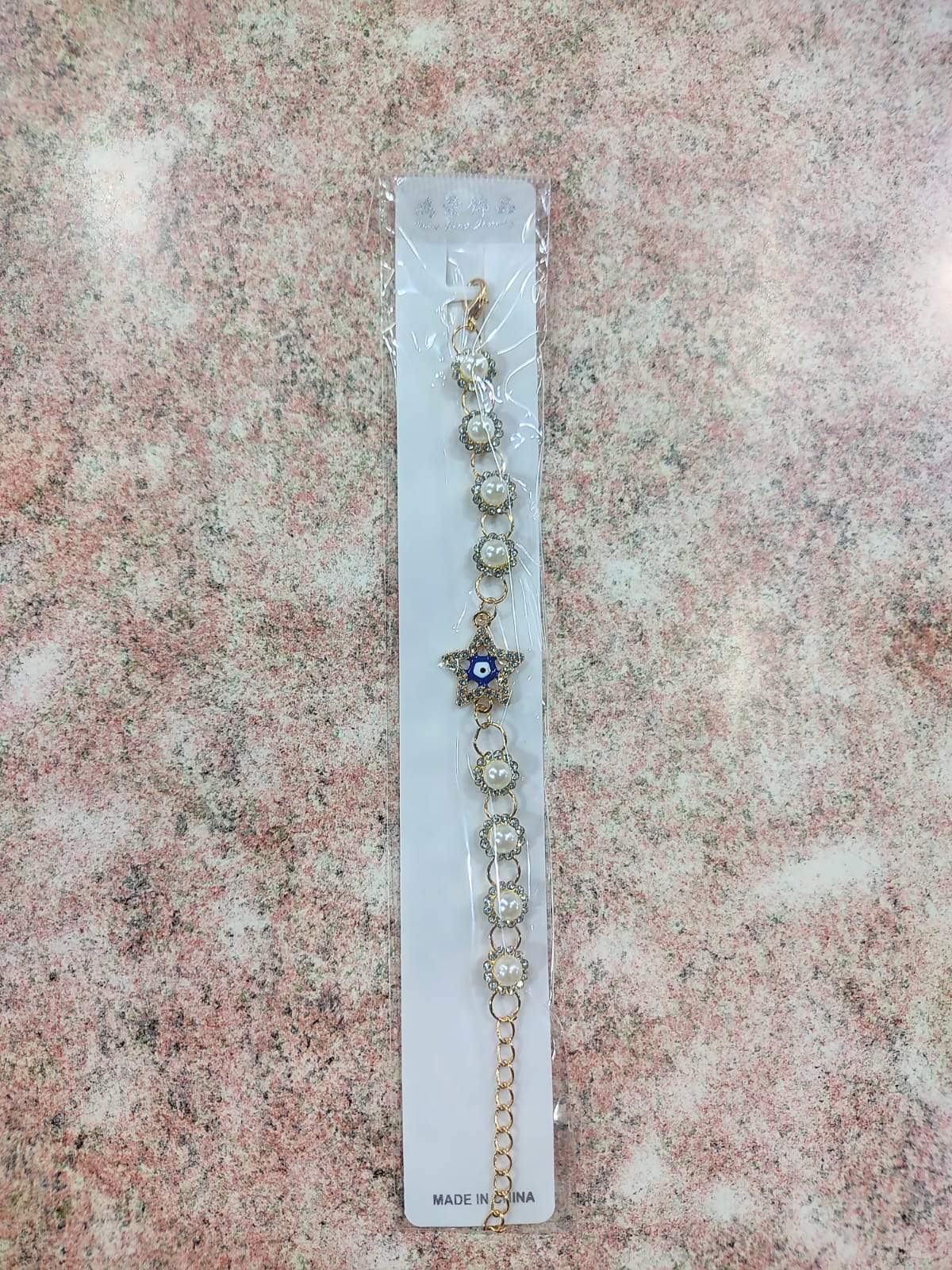 ✨ Pulsera Dorada con Perla, Ojo Turco y Dijes Variados – Por Docena ✨
