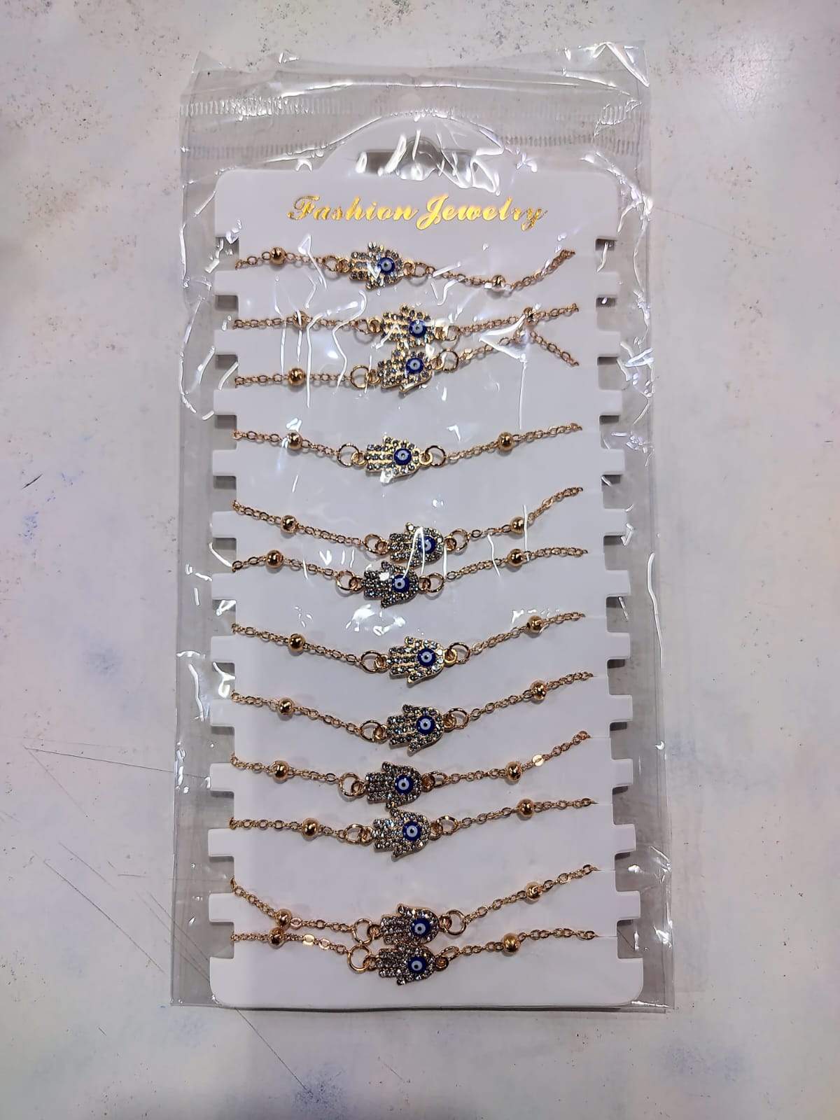 ✨ PULSERAS DORADAS MANO DE FÁTIMA CON OJO TURCO – PACK x12 ✨