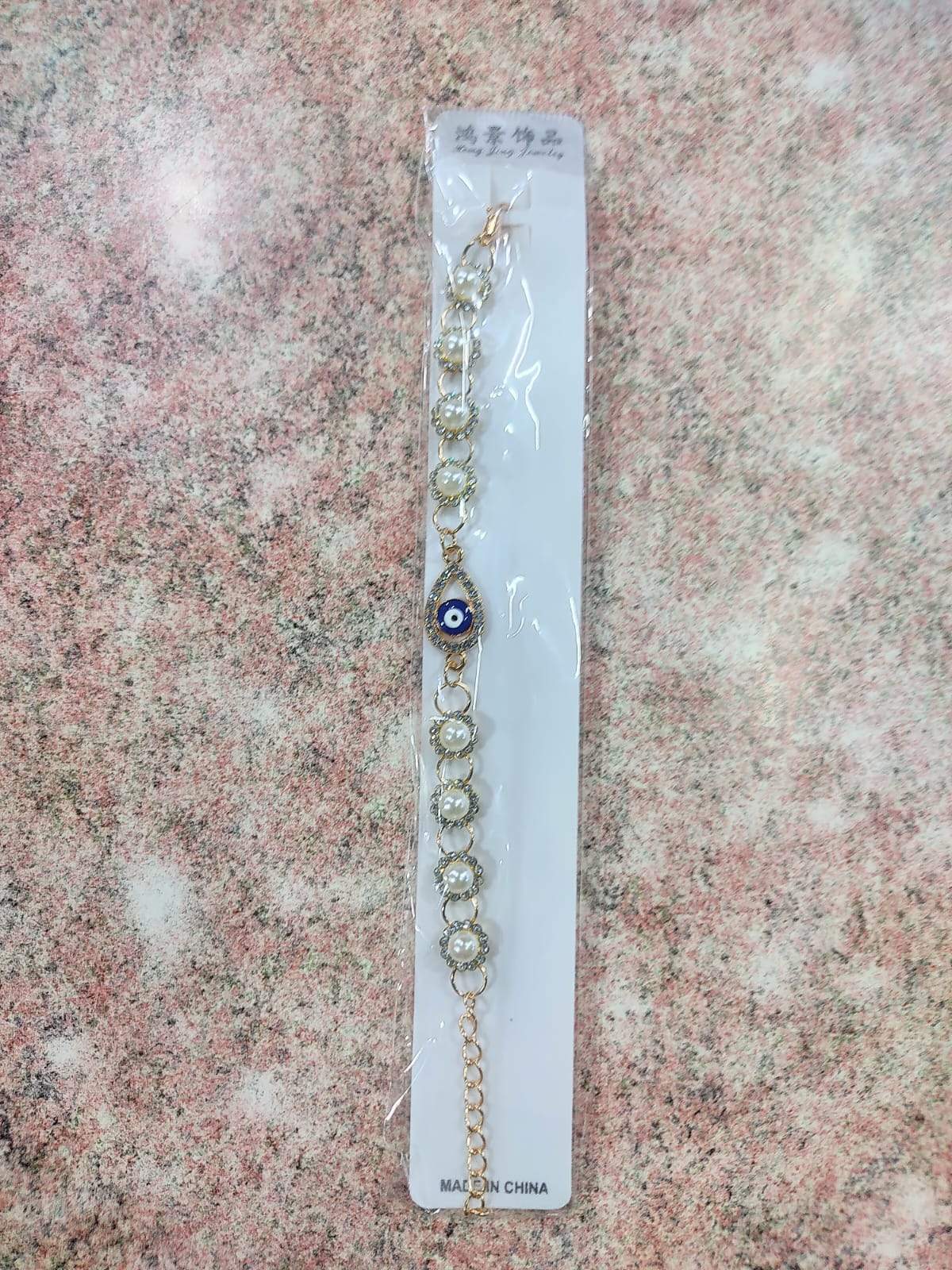✨ Pulsera Dorada con Perla, Ojo Turco y Dijes Variados – Por Docena ✨